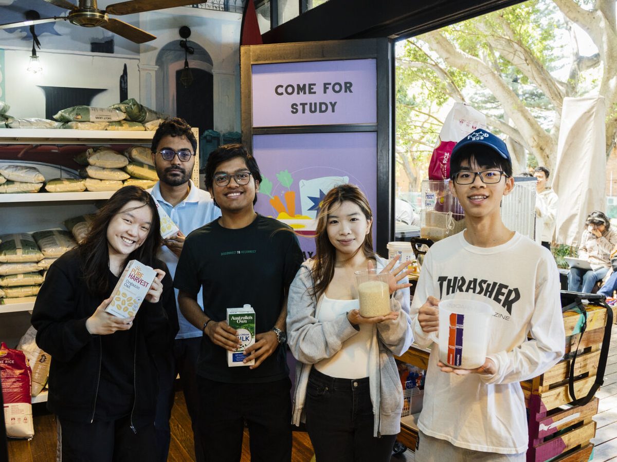 Four students holding rice, milk and oat milk at the Arc Food Hub on the UNSW Kensington campus